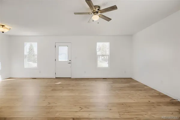 wooden floor in an empty room with a window