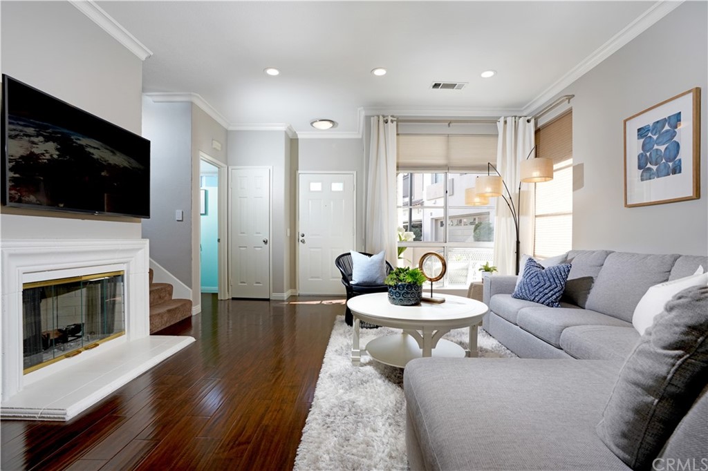 10 Westerly Aliso Viejo, CA 92656 - Photo 5 of 29 a living room with furniture a flat screen tv and a fireplace