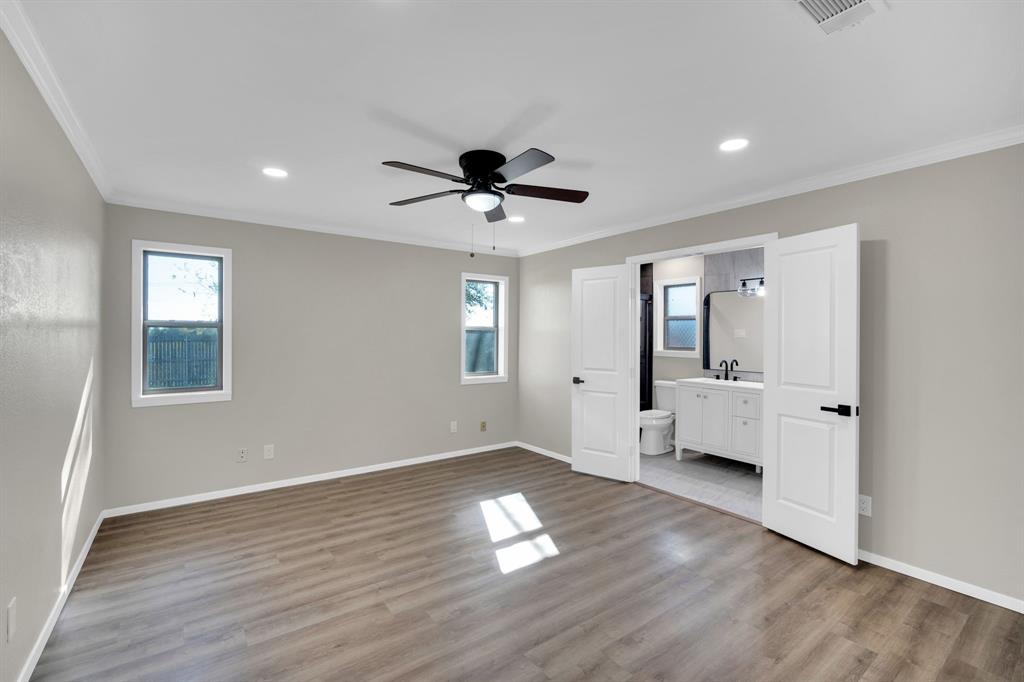 221 North Edgefield Road Waxahachie, TX 75165 - Photo 11 of 27 a view of an empty room with a window and wooden floor