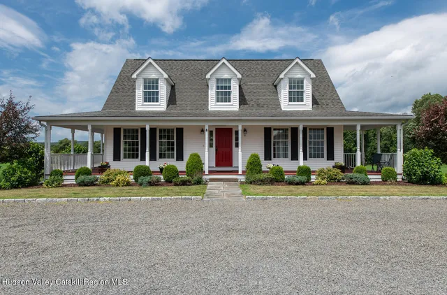 front view of a brick house with a yard