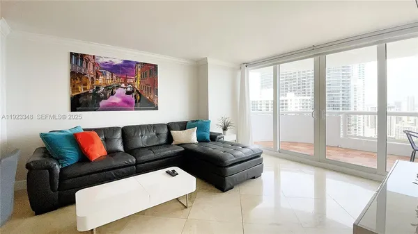 a living room with furniture and a large window