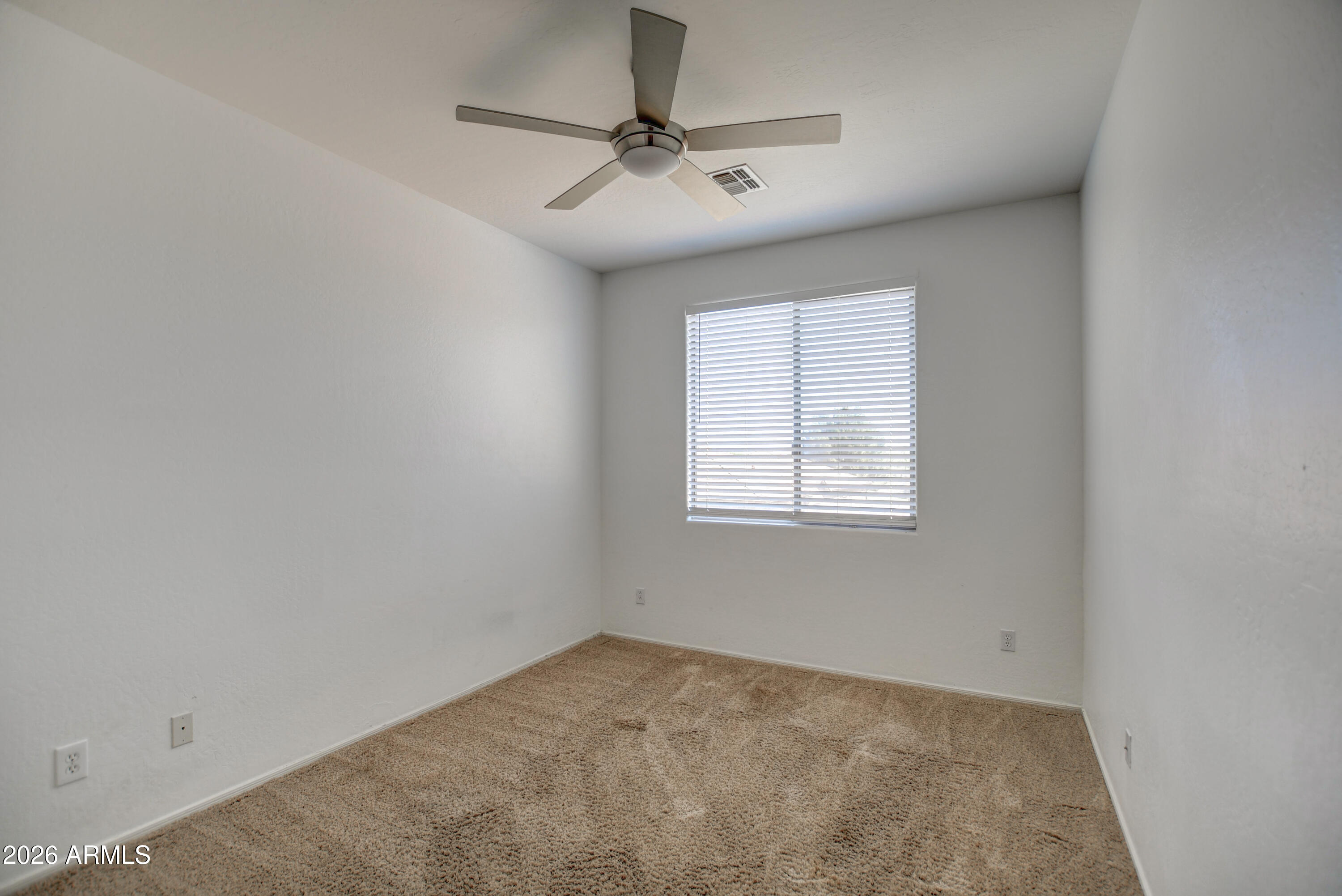 3078 East Muirfield Street Gilbert, AZ 85298 - Photo 69 of 92 an empty room with a ceiling fan and window