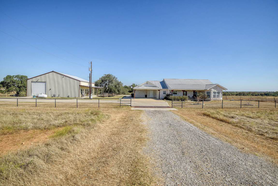 603 Watterson Road, Unit B AND C Bastrop, TX 78602 - Photo 1 of 40 a view of swimming pool with outdoor seating and house in the background