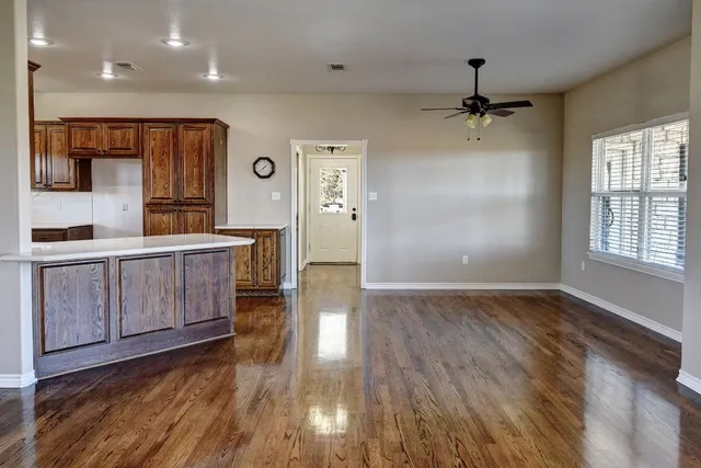 a view of a room with wooden floor and entryway