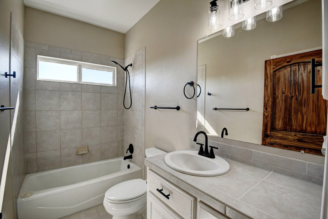 603 Watterson Road, Unit B AND C Bastrop, TX 78602 - Photo 17 of 40 a bathroom with a sink a toilet and shower