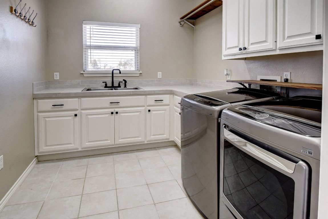 603 Watterson Road, Unit B AND C Bastrop, TX 78602 - Photo 18 of 40 a kitchen with granite countertop white cabinets stainless steel appliances and sink