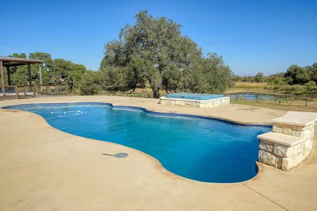 a view of a swimming pool with an outdoor seating and yard
