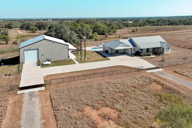 an aerial view of a house with a yard