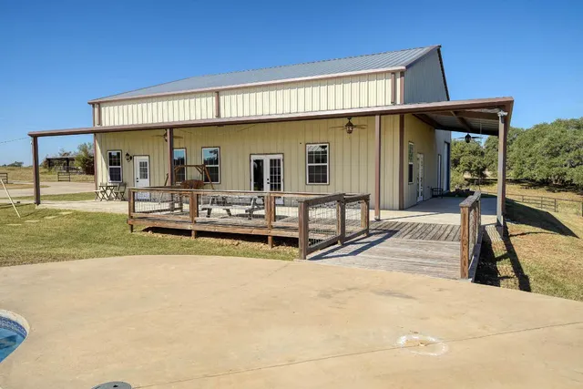 a view of a house with backyard porch and furniture