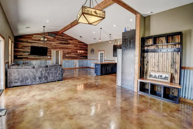 a view of a livingroom with furniture and kitchen view