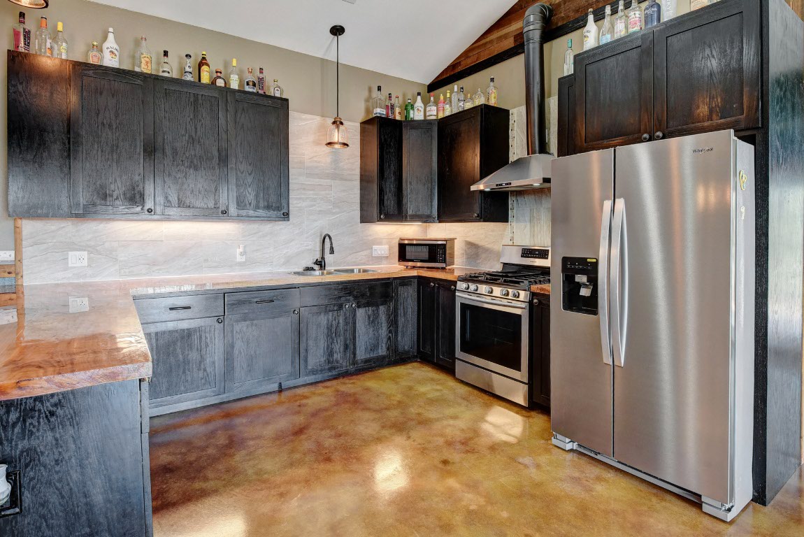 603 Watterson Road, Unit B AND C Bastrop, TX 78602 - Photo 26 of 40 a kitchen with stainless steel appliances a refrigerator a sink and a stove
