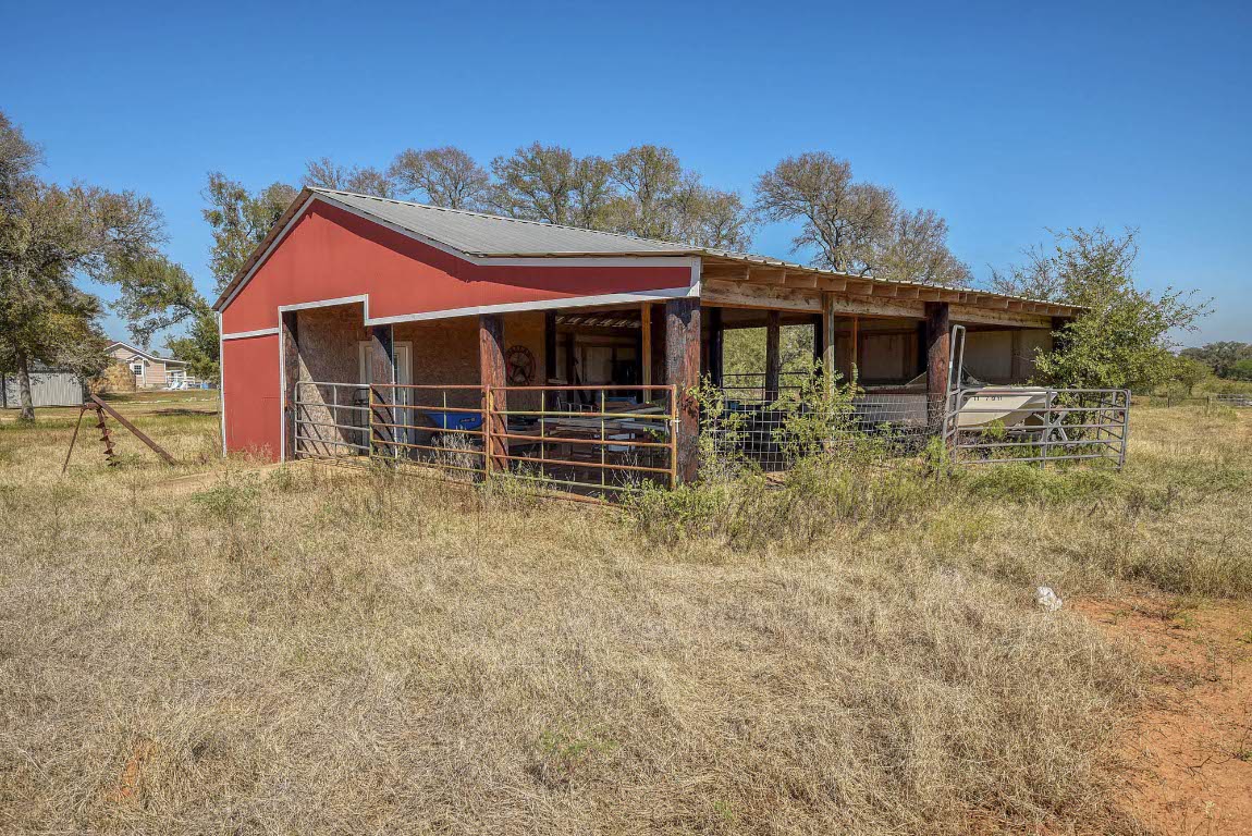 603 Watterson Road, Unit B AND C Bastrop, TX 78602 - Photo 32 of 40 a house with lots of trees in the background