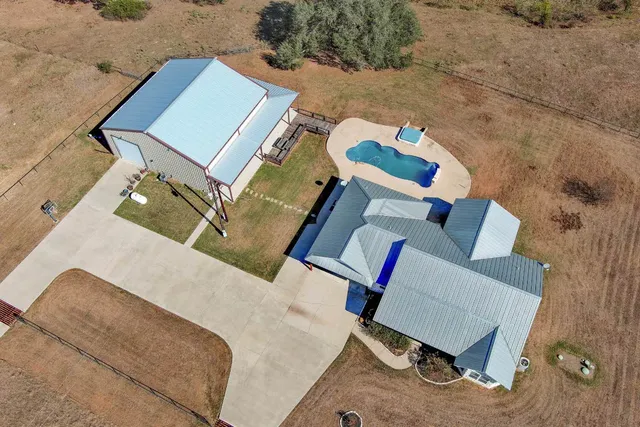 an aerial view of a house with a yard