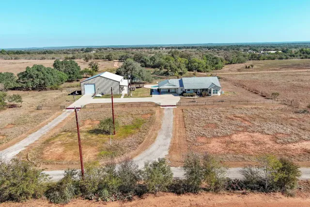 an aerial view of a house with a ocean view