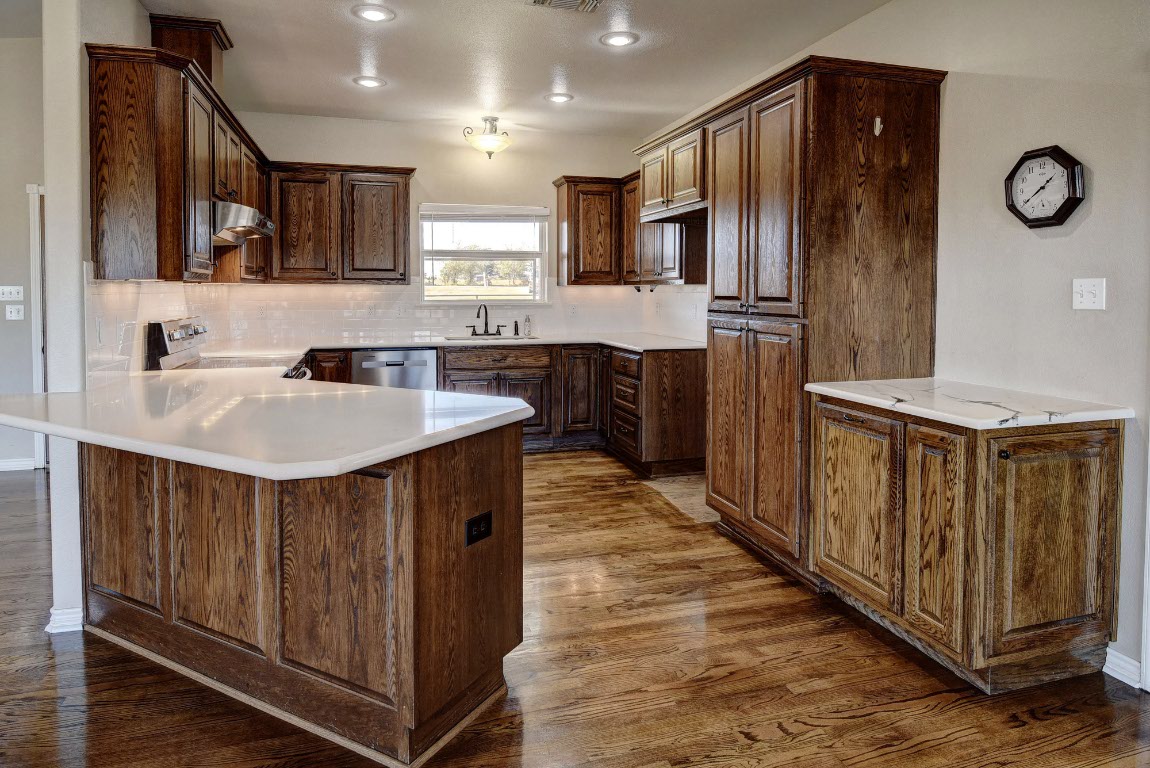 603 Watterson Road, Unit B AND C Bastrop, TX 78602 - Photo 9 of 40 a kitchen with stainless steel appliances a sink cabinets and wooden floor