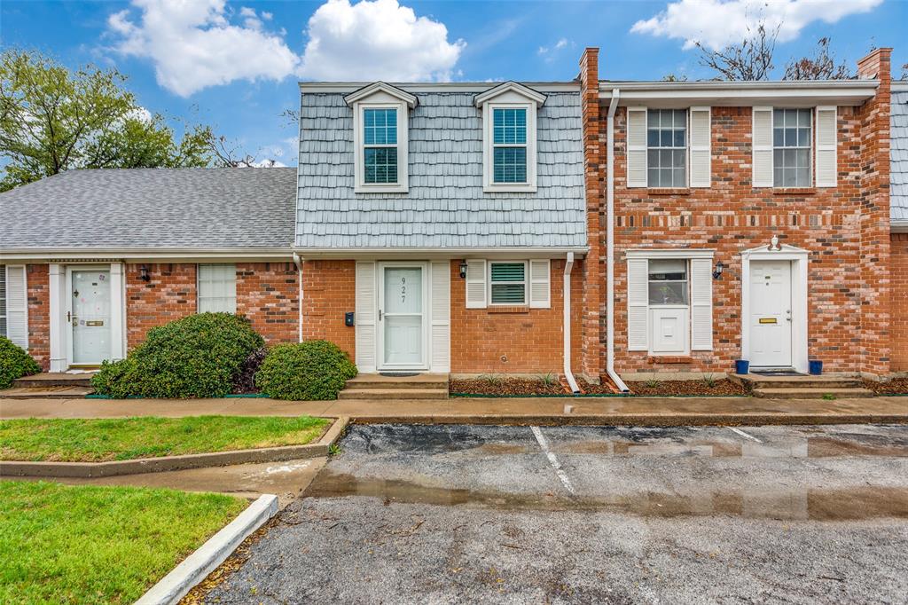 a front view of a house with a yard and potted plants