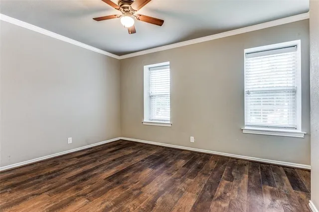 a view of a room with wooden floor and windows