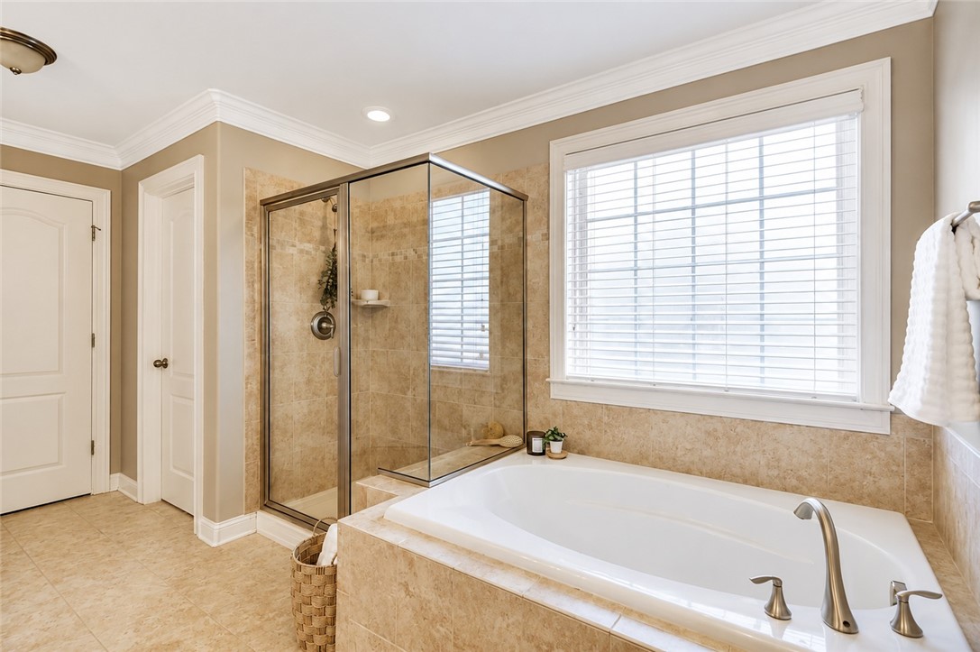 15 Fawn Hill Drive Anderson, SC 29621 - Photo 25 of 38 This serene bathroom offers a luxurious soaking tub and a spacious walk-in shower for ultimate relaxation.