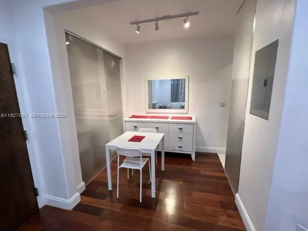 a workspace with wooden floor and furniture