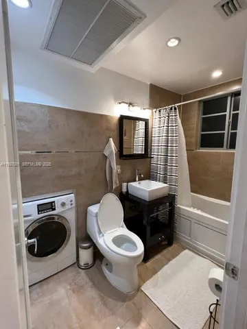 a bathroom with a toilet a sink and bathtub