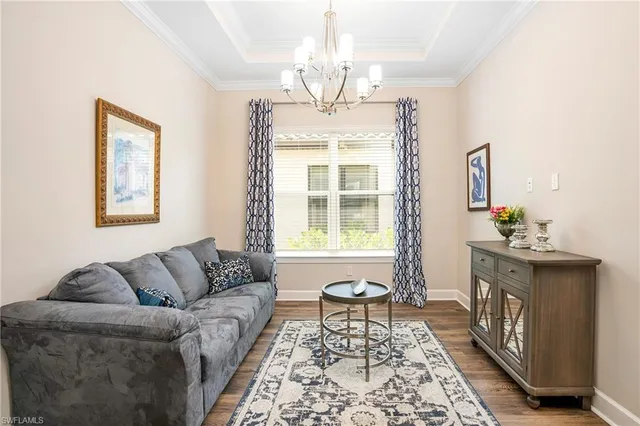 a living room with furniture and a chandelier
