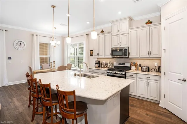 a kitchen with a dining table chairs and white cabinets