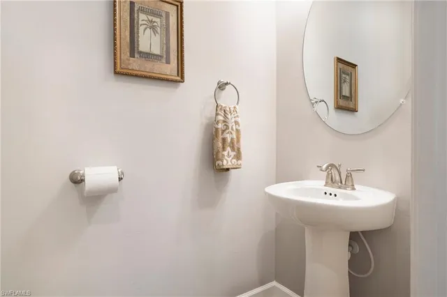 a bathroom with a sink a mirror and a window