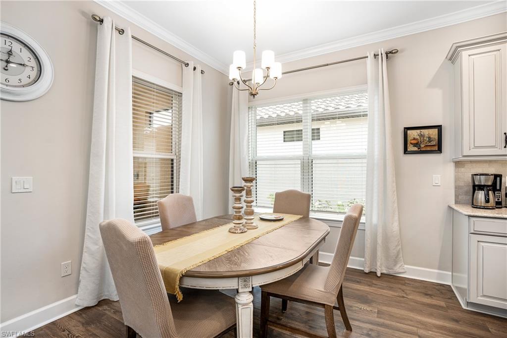 8131 Lucello Terrace North Naples, FL 34114 - Photo 4 of 32 a view of a dining room with furniture window and wooden floor