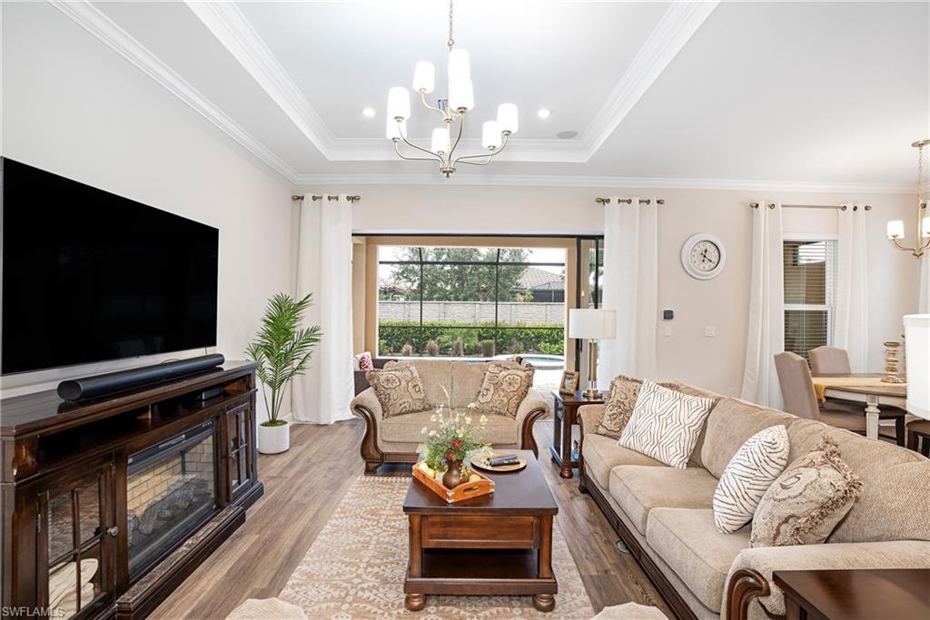 8131 Lucello Terrace North Naples, FL 34114 - Photo 7 of 32 a living room with furniture and a flat screen tv