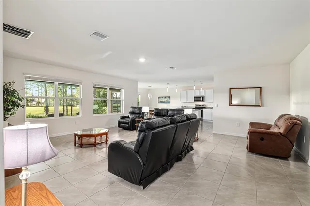 a living room with furniture and a mirror