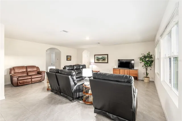 a kitchen with granite countertop white cabinets and stainless steel appliances