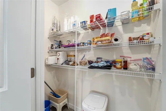 a view of walk in closet with clothes