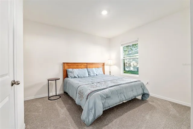 an aerial view of a house with a yard basket ball court and outdoor seating