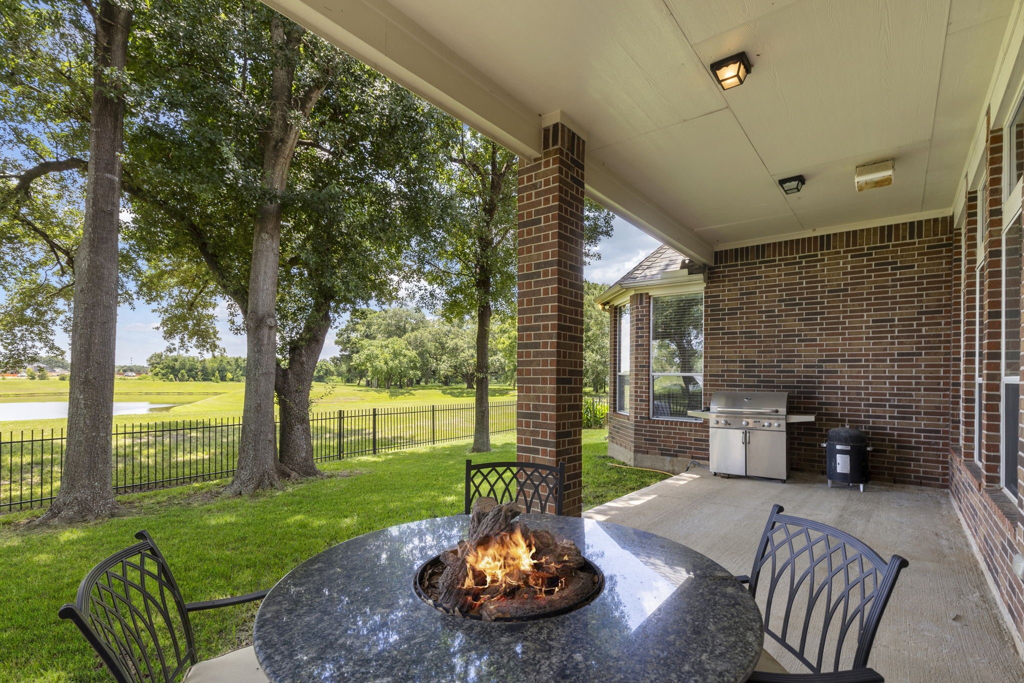 19222 Senterra Lakes Boulevard Spring, TX 77379 - Photo 33 of 45 Relax in style under the deep covered patio, complete with a ceiling fan—perfect for outdoor dining, grilling, or enjoying cool evenings.
