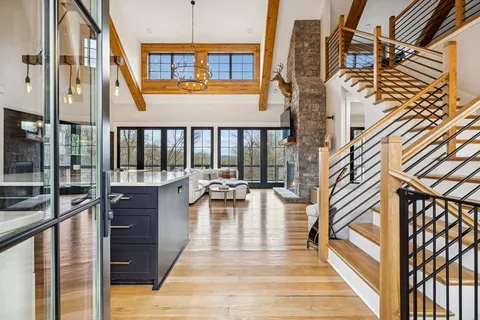 a view of balcony with chairs and wooden floor