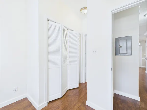 a view of a room with wooden floor