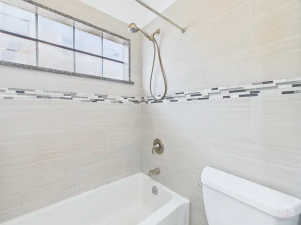 a bathroom with a shower a toilet and sink