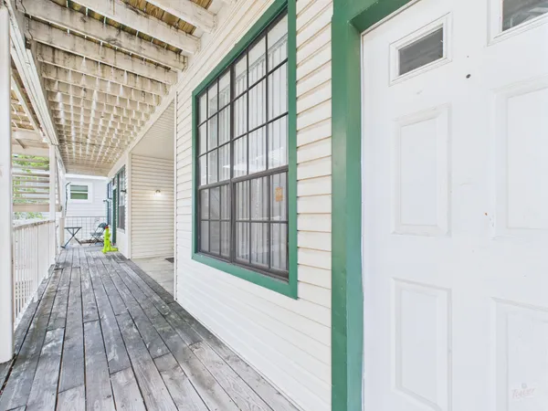 a view of outdoor space with wooden floor and windows