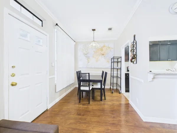 a view of a dining room with furniture and wooden floor