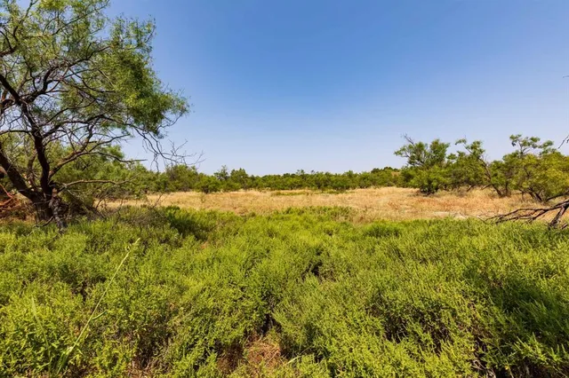 a view of a lake with a house in background