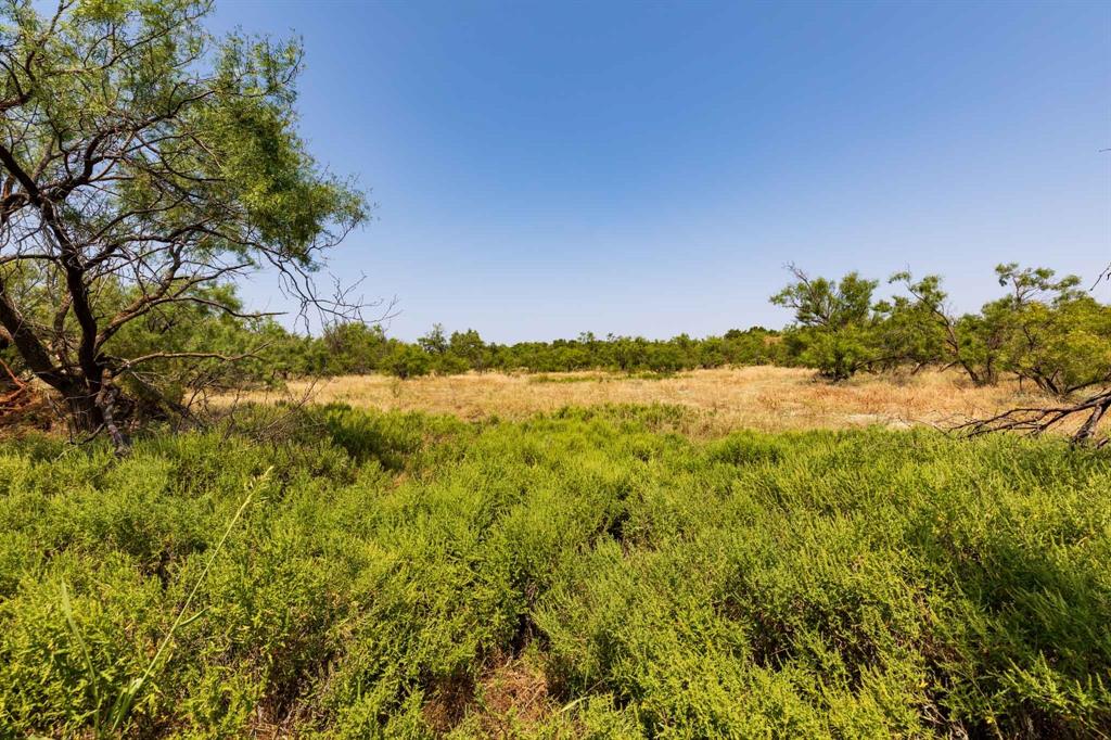 349 C R 349 Aspermont, TX 79502 - Photo 8 of 24 a view of a lake with a house in background