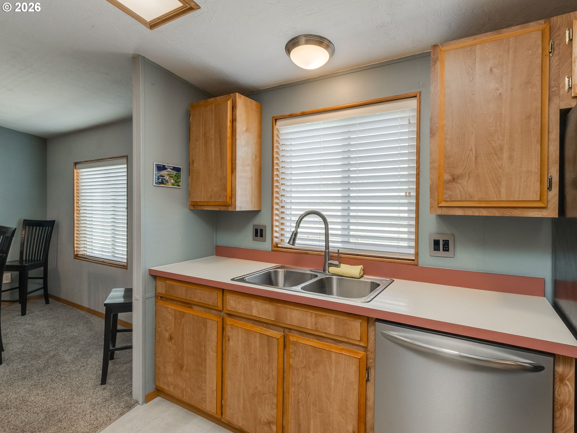 4730 Auburn Road Northeast, Unit 125 Salem, OR 97301 - Photo 11 of 36 a kitchen with stainless steel appliances granite countertop a sink and a wooden cabinets