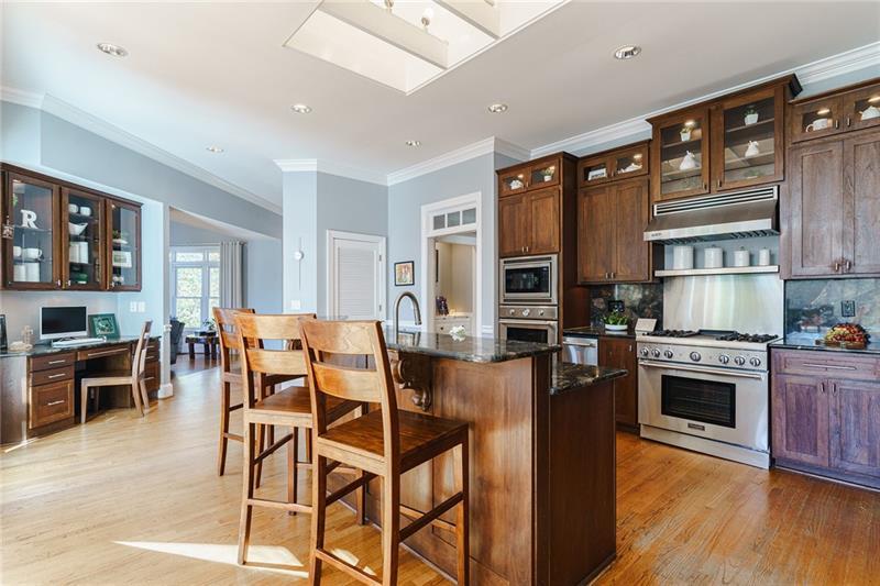 1801 Birmingham Road Milton, GA 30004 - Photo 30 of 102 a kitchen with stainless steel appliances granite countertop a stove top oven a sink dishwasher a dining table and chairs with wooden floor