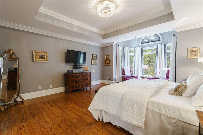 1801 Birmingham Road Milton, GA 30004 - Photo 48 of 102 a spacious bedroom with a bed and a flat screen tv