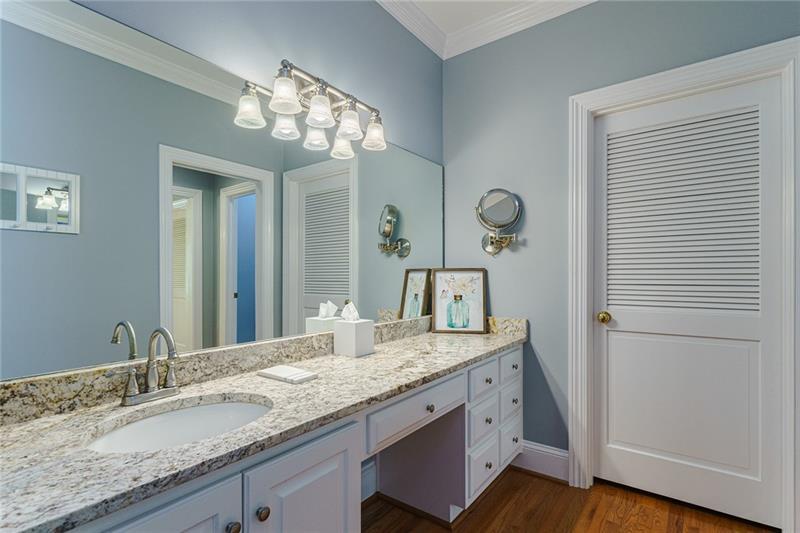 1801 Birmingham Road Milton, GA 30004 - Photo 55 of 102 a bathroom with a granite countertop sink a light fixture and a mirror