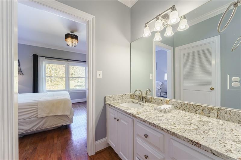1801 Birmingham Road Milton, GA 30004 - Photo 57 of 102 a en suite bathroom with a granite countertop sink and a mirror