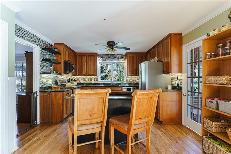 1801 Birmingham Road Milton, GA 30004 - Photo 94 of 102 a kitchen with stainless steel appliances granite countertop a refrigerator and wooden cabinets