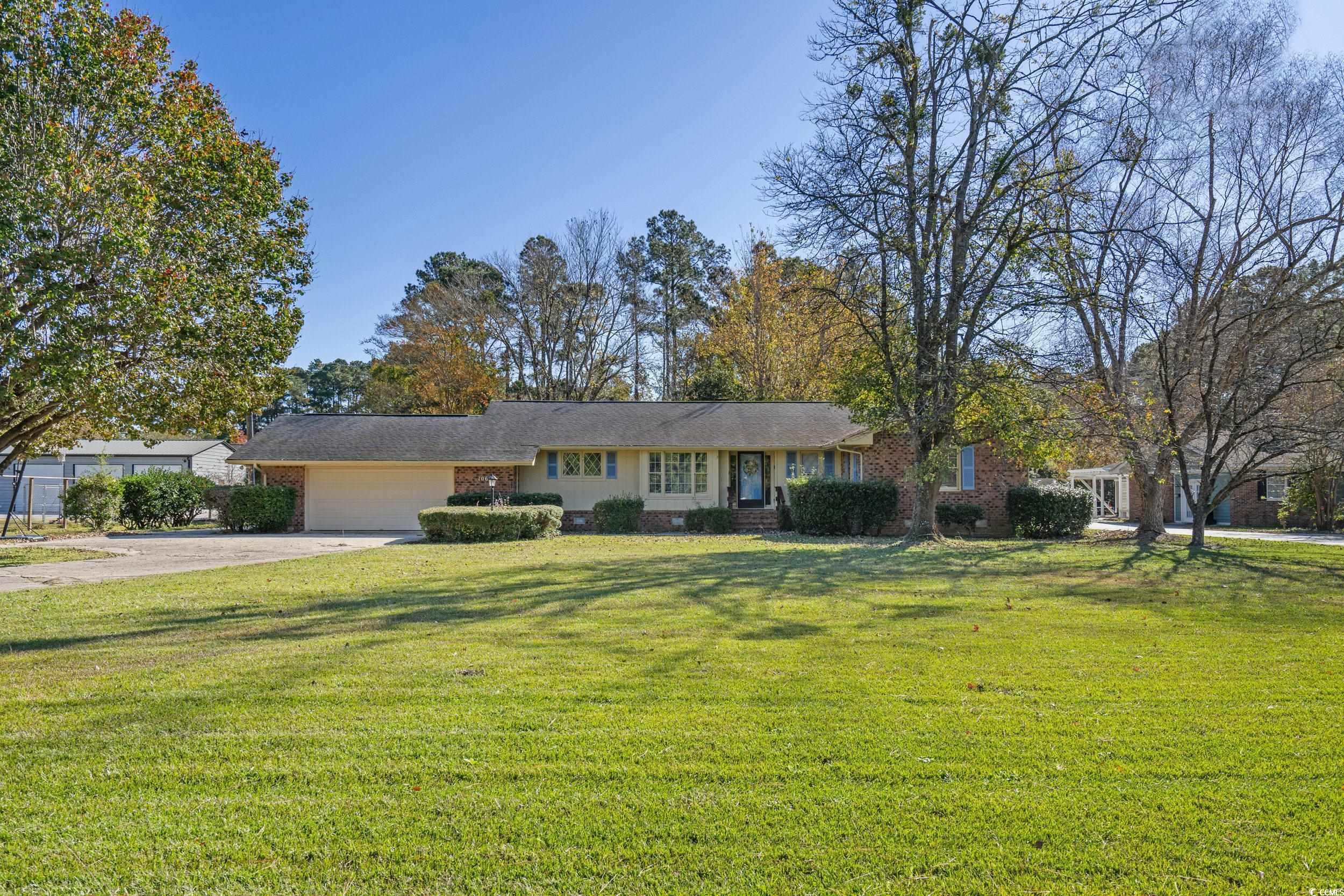 1063 Burcale Road Myrtle Beach, SC 29579 - Photo 2 of 36 Ranch-style house with a front lawn, driveway, a garage, brick siding, and crawl space