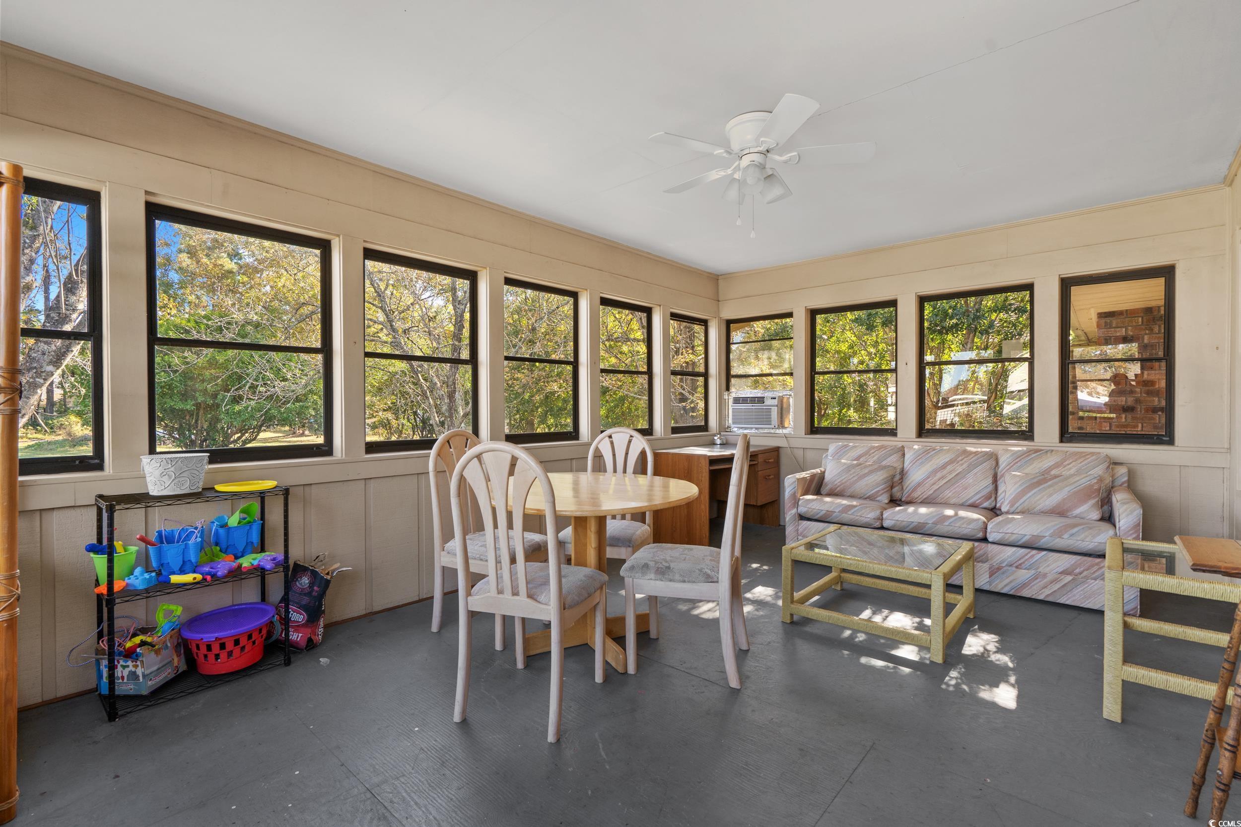 1063 Burcale Road Myrtle Beach, SC 29579 - Photo 21 of 36 Sunroom / solarium featuring concrete floors and wooden walls