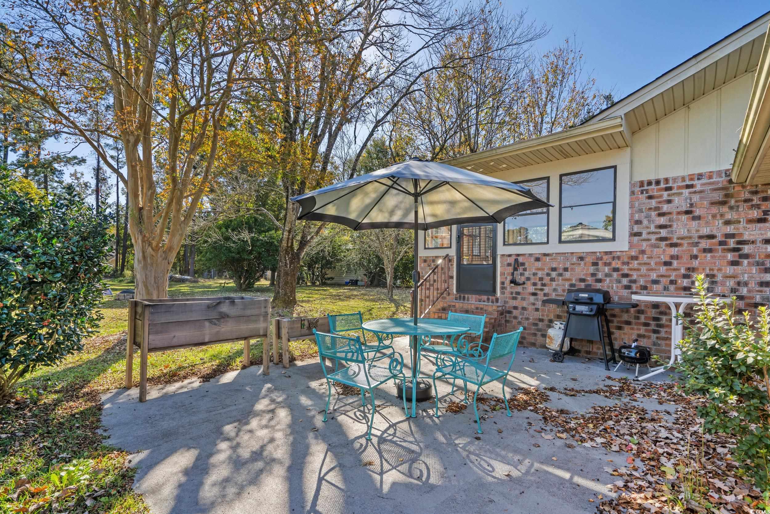 1063 Burcale Road Myrtle Beach, SC 29579 - Photo 22 of 36 View of patio / terrace featuring outdoor dining space and area for grilling